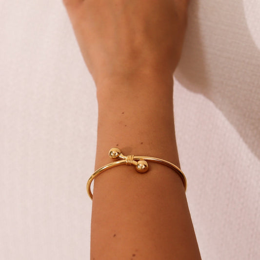 Pulseira Bracelete Nó Torcido com Esferas Dourado